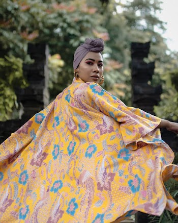 Woman Wearing A Floral Dress And Headscarf