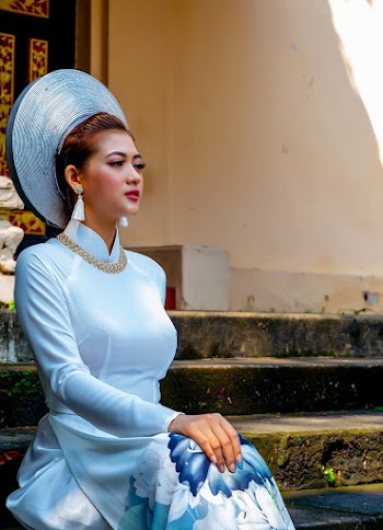 Woman Wearing A Floral Long Sleeved Dress Sitting on Concrete Stairs