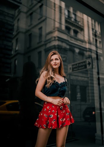 Woman Wearing A Mini Skirt And Black Spaghetti Strap Top