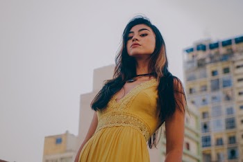 Woman Wearing a Plunging Yellow Sleeveless Dress