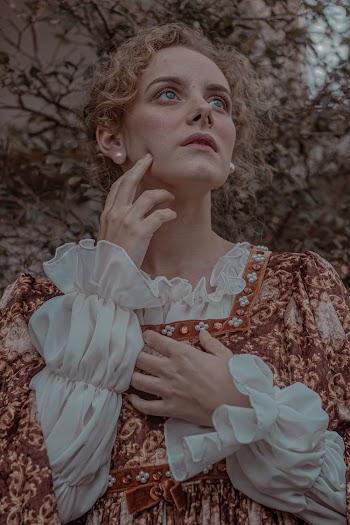 Woman Wearing A Printed Long-sleeved Dress Under Green-leafed Tree
