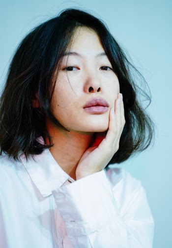 Woman Wearing a White Button Up Shirt with Hand on Cheek · Free Stock Photo