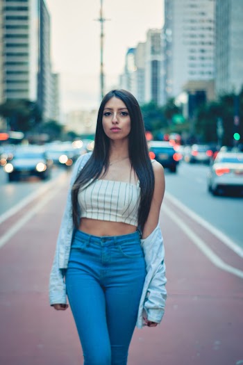 Woman Wearing A White Top And Blue Pants