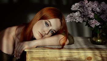 Woman wearing an off shoulder top lying on a table