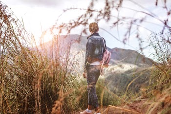 Woman Wearing Backpack Under Blue Sky