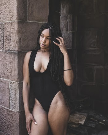 Woman Wearing Bathing Suit While Leaning on Wall