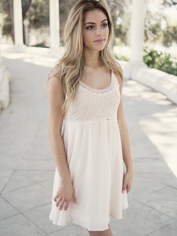 Woman Wearing Beige Dress Standing Inside Structure