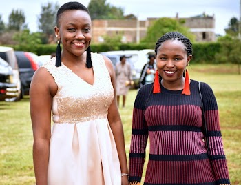 Woman Wearing Beige Sleeveless Dress Beside Woman Wearing Black and Maroon Sweater