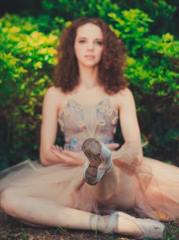 Woman Wearing Beige Spaghetti Strap Dress Sitting on Ground Near Green Plant Outdoor