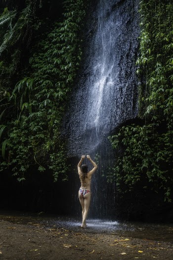 Woman Wearing Bikini Standing Near Waterfalls