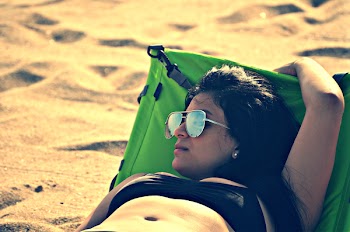 Woman Wearing Bikini Top Lying on Bed Beside Sand at Daytime