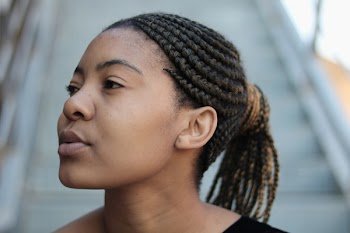 Woman Wearing Black and and Brown Scrunchies Looking Sideways Near Stairs