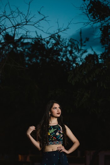 Woman Wearing Black and Multicolored Sleeveless Crop-top Holding Her Hair