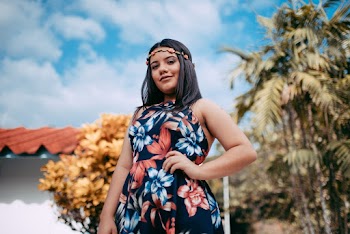 Woman Wearing Black and Orange Floral Dress and Floral Headband