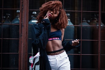 Woman Wearing Black and Pink Diesel Sports Bra With Black Jacket and White Bottoms Outfit