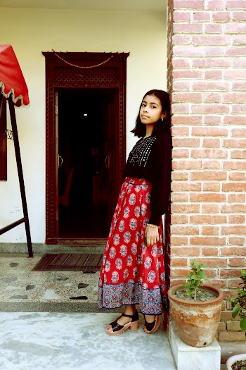Woman Wearing Black-and-red Long-sleeved Long Dress Leaning to Wall