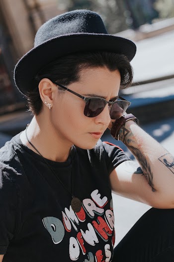 Woman Wearing Black and White Crew-neck T-shirt and Black Hat