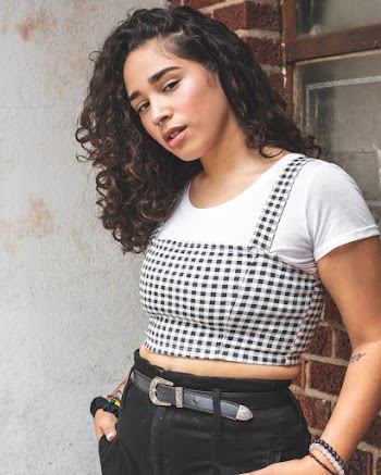 Woman Wearing Black and White Crop Top Standing Beside Wall