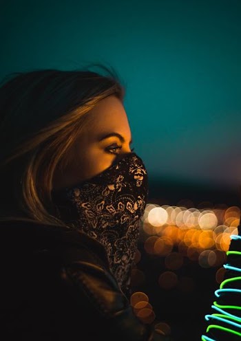 woman wearing black and white floral face mask during nighttime