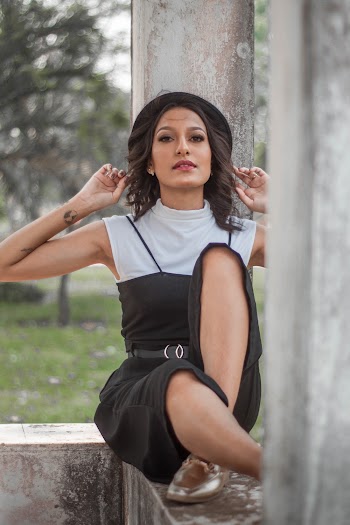 Woman Wearing Black and White Sleeveless Rompers
