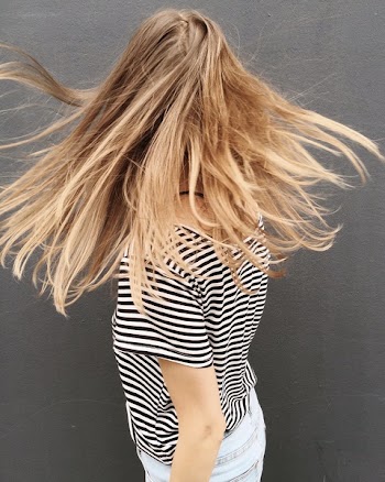 Woman Wearing Black and White Stripe Blouse