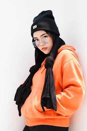 Woman Wearing Black Beanie While Leaning on White Wall