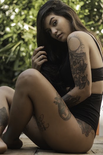 Woman Wearing Black Bikini Sitting on Ground