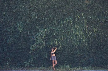 woman wearing black bikini top and blue shorts