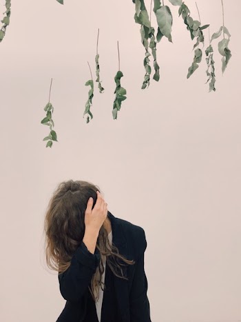Woman Wearing Black Blazer Beside White Wall