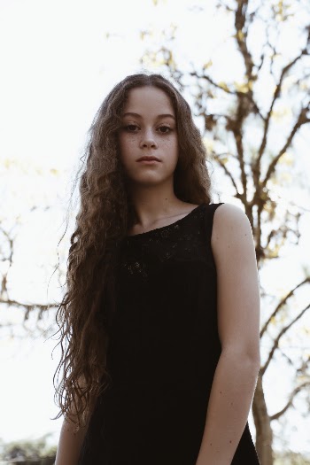 Woman Wearing Black Boat-neck Sleeveless Dress