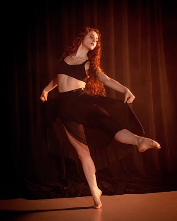 Woman Wearing Black Bra and Mesh Silt Skirt Dancing on Stage