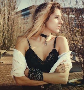 Woman Wearing Black Bra and White Blazer Facing Her Left Side