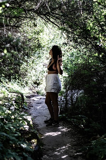 Woman Wearing Black Bra Standing Beside Green Plants