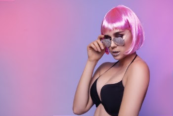 Woman Wearing Black Bralette Holding Her Sunglasses