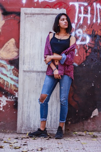 Woman Wearing Black Camisole And Blue Denim Jeans