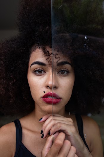 Woman Wearing Black Camisole Leaning on Glass