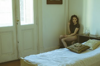Woman Wearing Black Cap-sleeved Top Sitting on Chair Near Bed