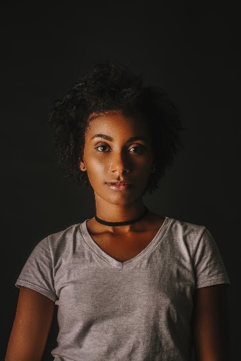 Woman Wearing Black Choker in Dark Room