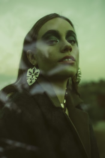 Woman Wearing Black Coat and Silver Earrings