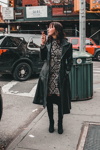 Woman Wearing Black Coat Smoking on Street