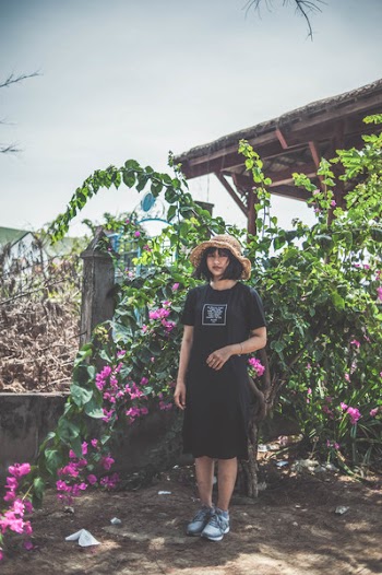 Woman Wearing Black Crew-neck Dress Standing Beside Pink Flowers