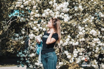 Woman Wearing Black Crew Neck Shirt And Blue Jeans