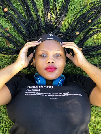 Woman Wearing Black Crew Neck Shirt Laying On Grass Field