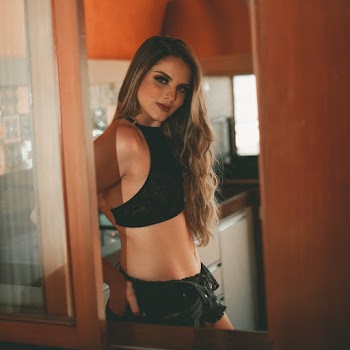 Woman Wearing Black Crop Top and Black Denim Shorts