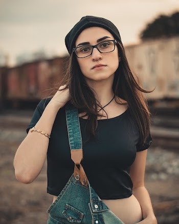 Woman Wearing Black Crop Top And Blue Overalls