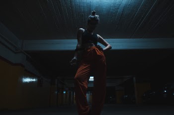 Woman Wearing Black Crop Top With Orange Pants