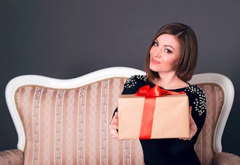 Woman Wearing Black Dress Holding A Gift