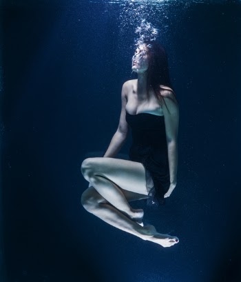 Woman Wearing Black Dress in Body of Water