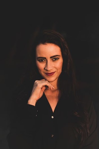 woman wearing black dress shirt making face