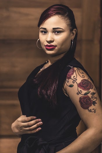 Woman Wearing Black Dress While Holding Her Tummy